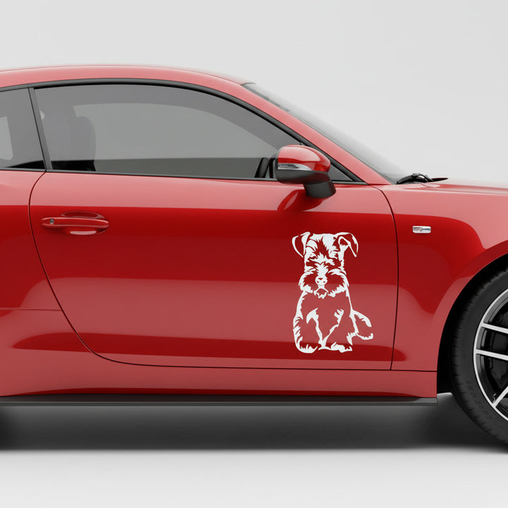 Weißer sitzender Cesky Terrier Ganzkörper Aufkleber an der Tür eines roten Autos, wetterfestes Autoaufkleber-Motiv von amberdog